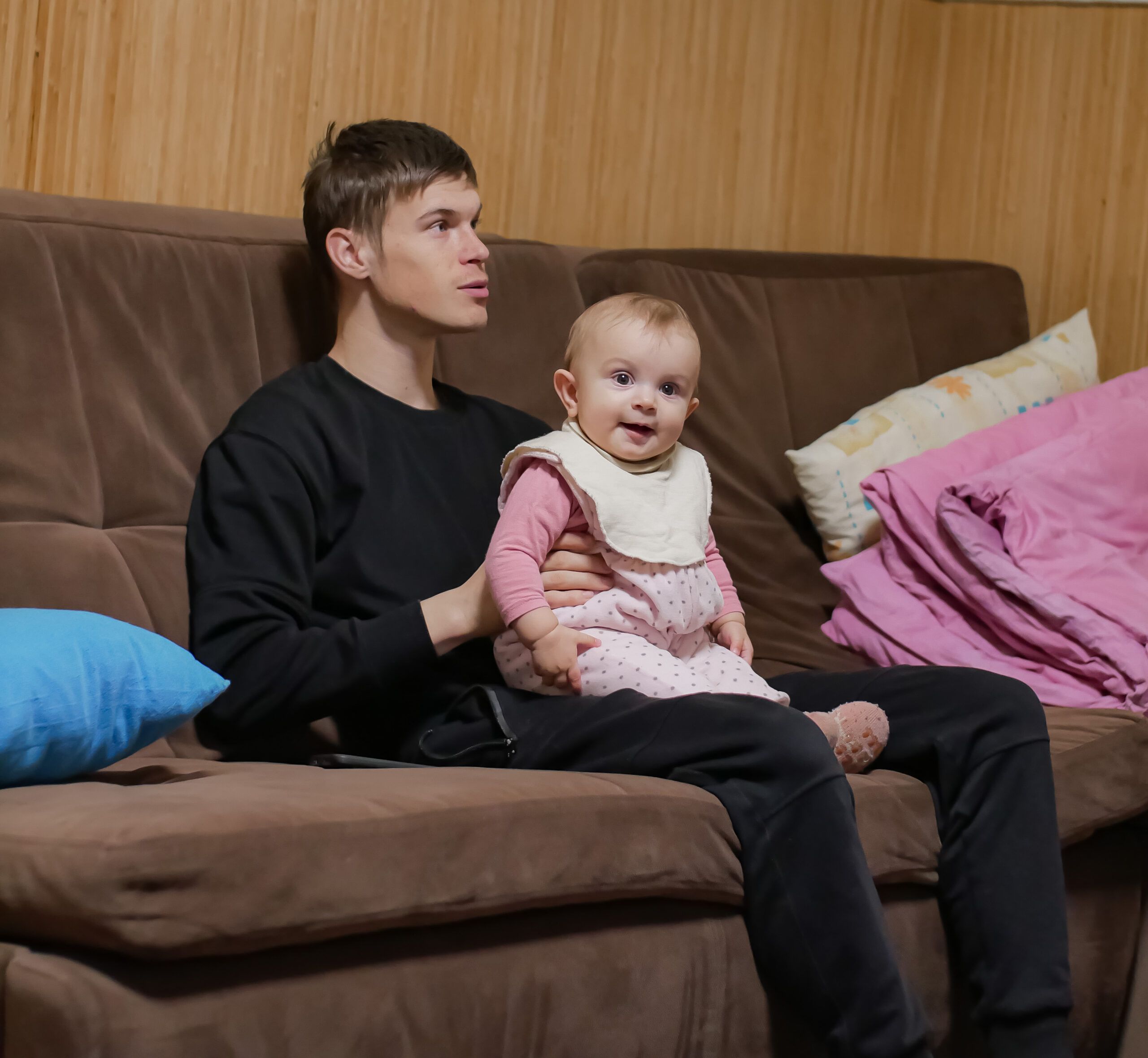 young dad on couch with baby