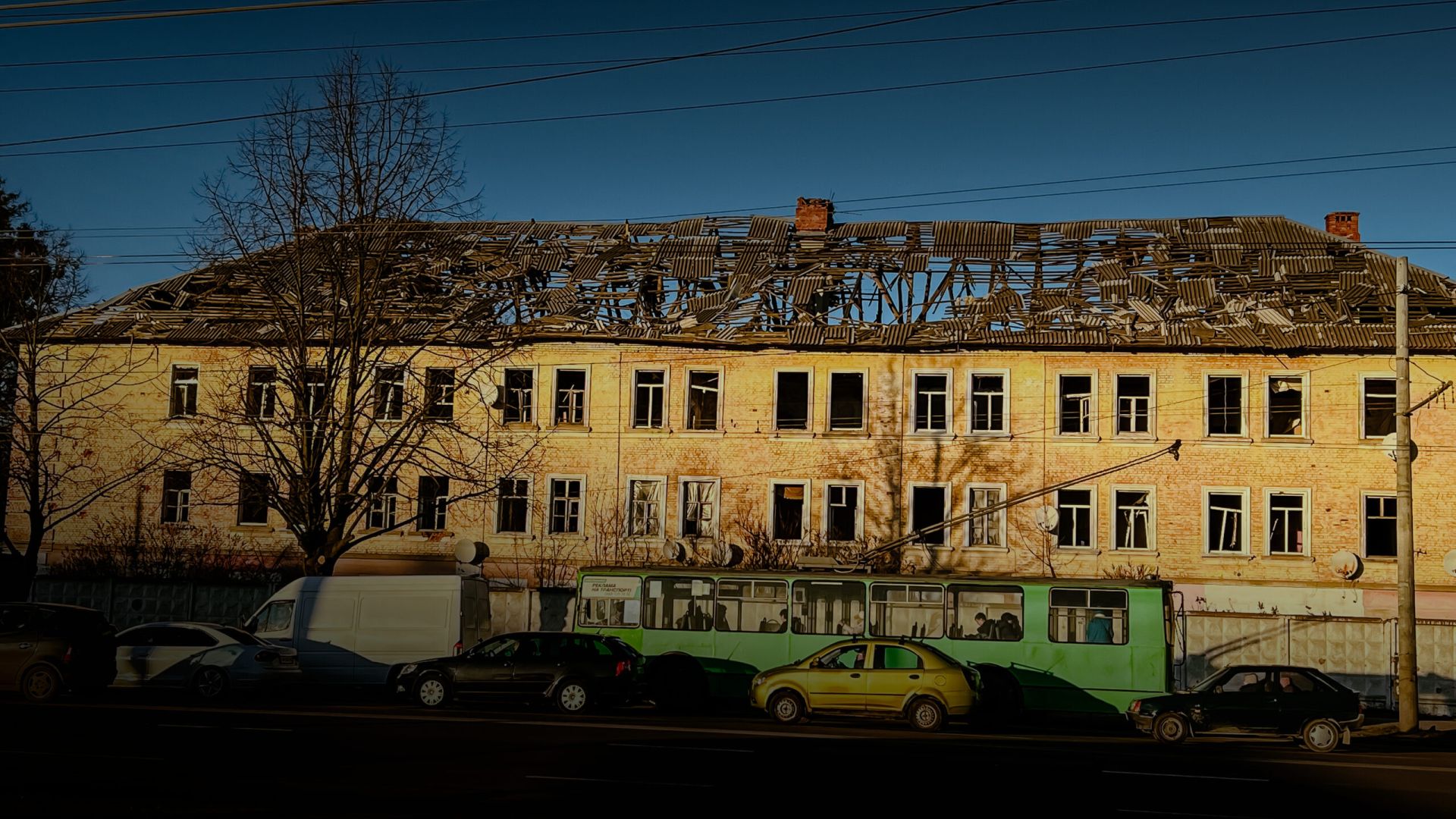 A long building with extensive damage to the roof